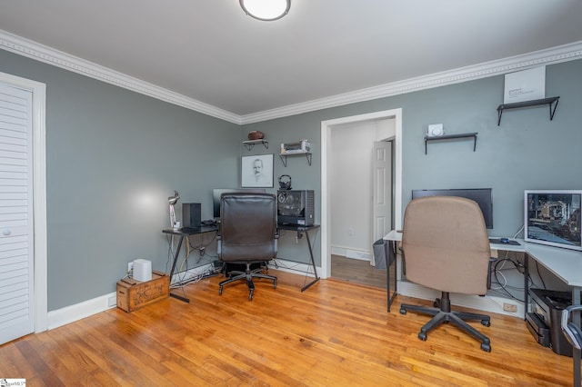 home office with light wood finished floors, baseboards, and crown molding