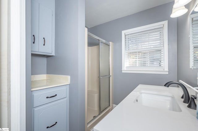 bathroom with a stall shower and vanity