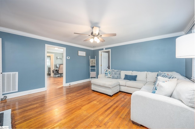 living area featuring ornamental molding, visible vents, baseboards, and wood finished floors