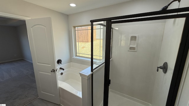 full bathroom with a stall shower, a bath, and recessed lighting