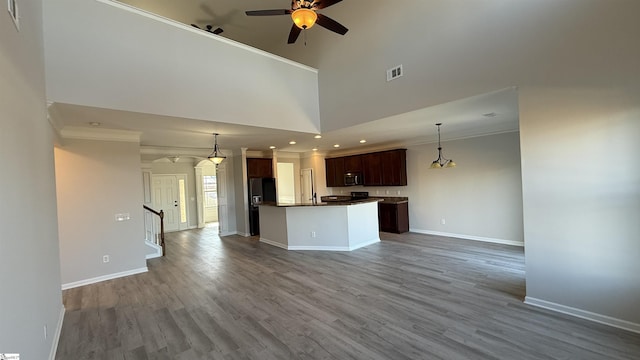 kitchen with pendant lighting, dark countertops, open floor plan, and visible vents