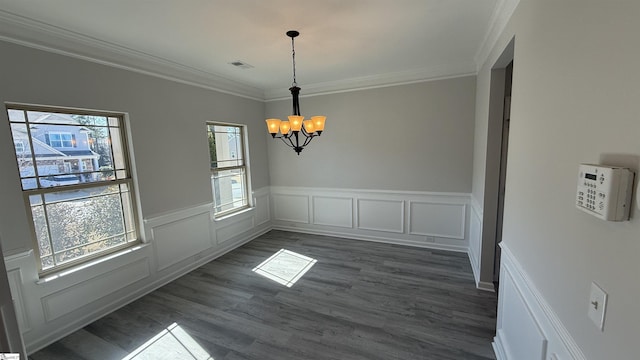 unfurnished dining area featuring visible vents, crown molding, a chandelier, and dark wood-style flooring