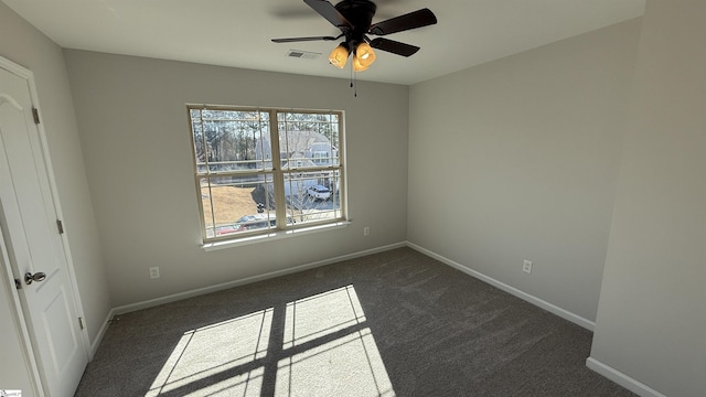 unfurnished bedroom with visible vents, dark carpet, baseboards, and ceiling fan