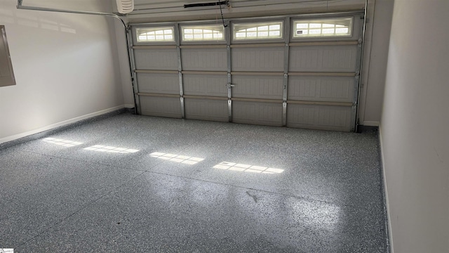 garage with electric panel and baseboards