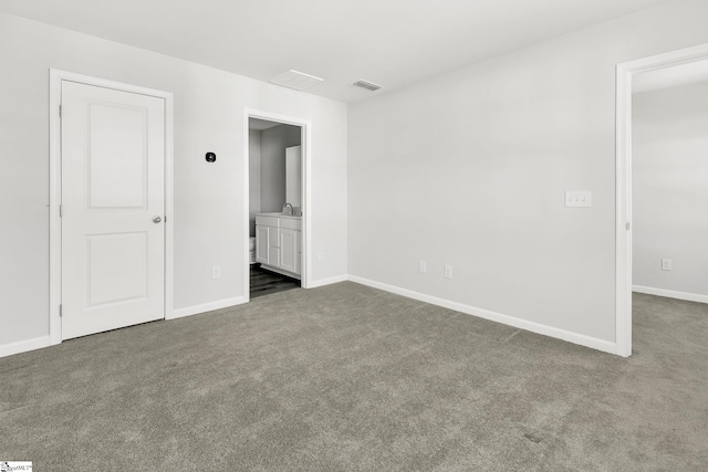 unfurnished bedroom with carpet, visible vents, ensuite bathroom, and baseboards