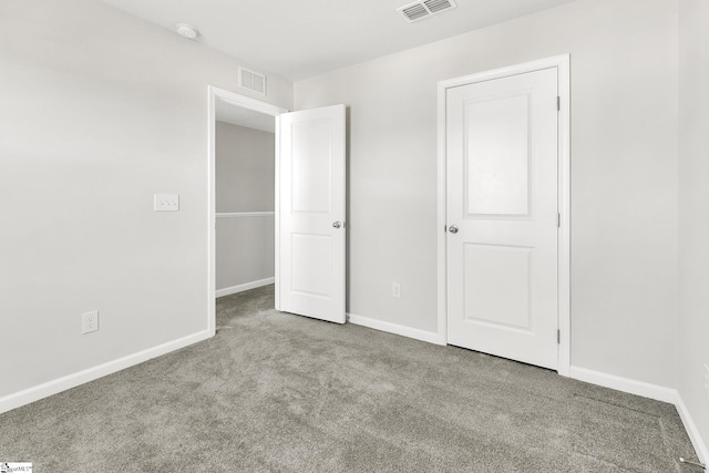 unfurnished bedroom featuring visible vents, baseboards, and carpet flooring