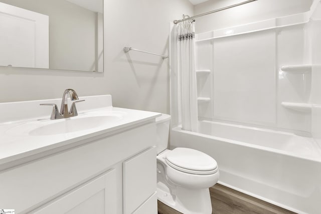 bathroom with shower / tub combo, toilet, wood finished floors, and vanity