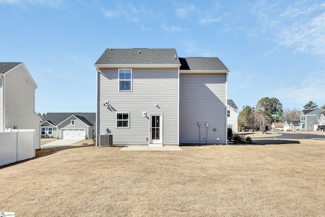 back of property featuring a yard, cooling unit, and a patio area