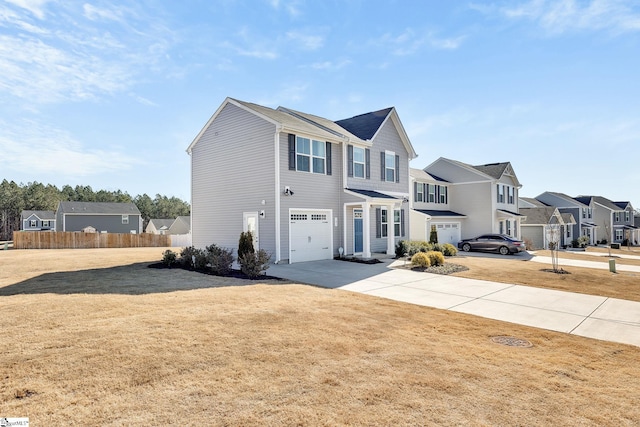 view of front facade featuring fence, concrete driveway, a front lawn, a garage, and a residential view