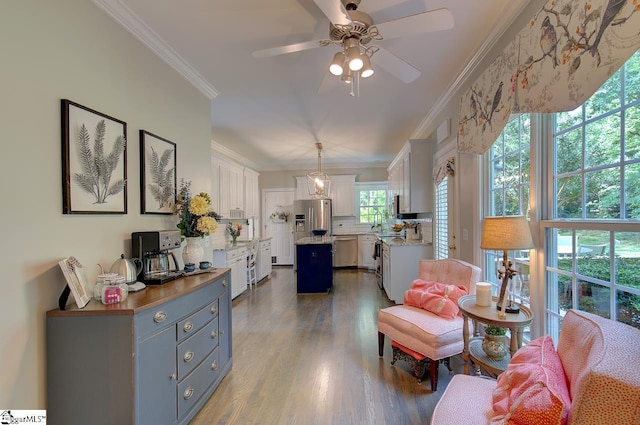 interior space featuring ornamental molding, wood finished floors, and a ceiling fan