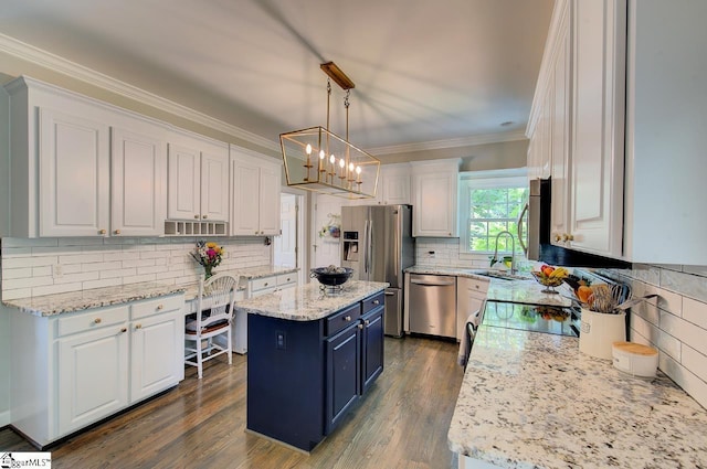 kitchen featuring pendant lighting, appliances with stainless steel finishes, white cabinetry, and a center island