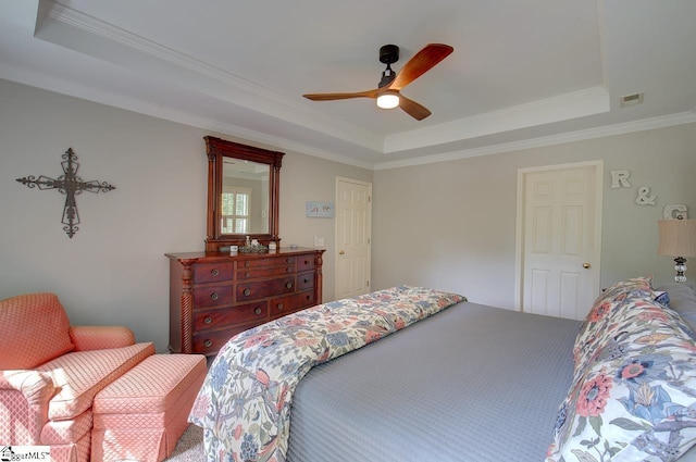 bedroom with ceiling fan, visible vents, a raised ceiling, and crown molding