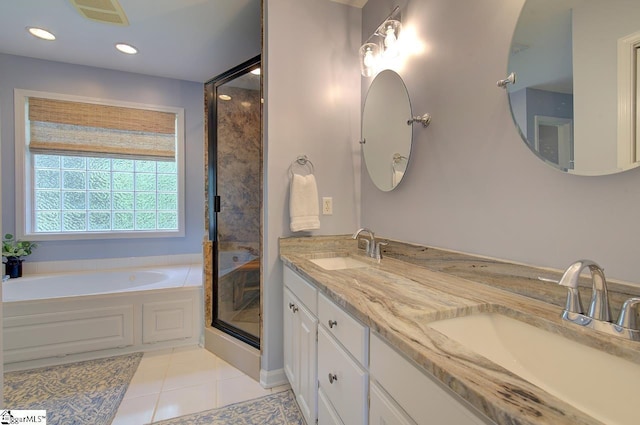 bathroom featuring a garden tub, visible vents, a sink, and tile patterned floors