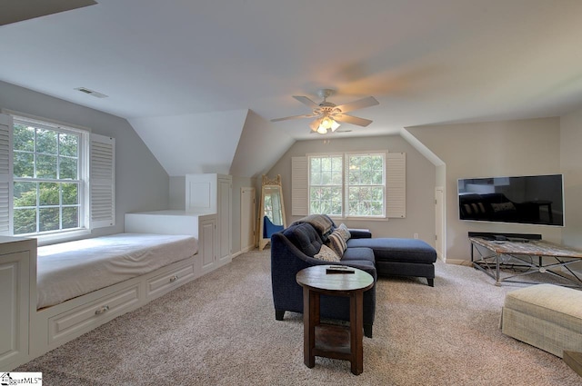 living area featuring light carpet, visible vents, a ceiling fan, and lofted ceiling