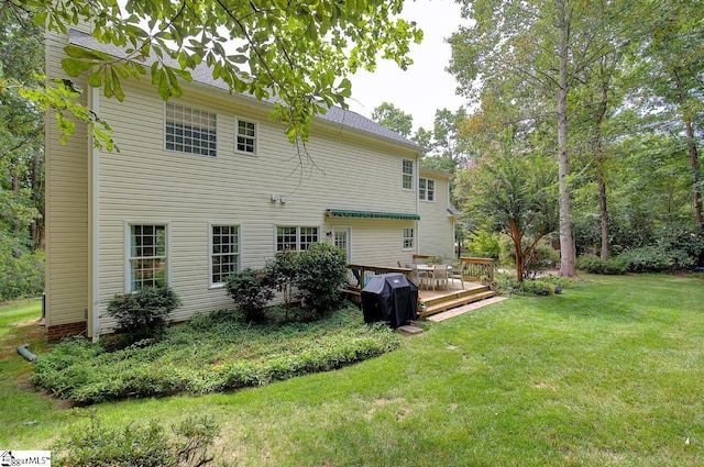 back of house featuring a deck and a yard