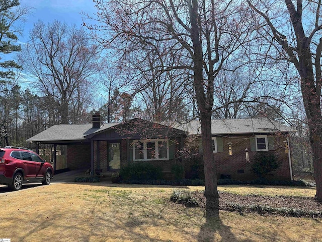 single story home featuring a carport, crawl space, brick siding, and a front lawn