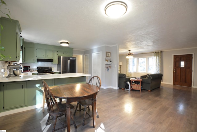 dining area with crown molding and dark wood-style flooring