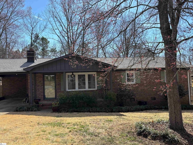 ranch-style house with crawl space, brick siding, a chimney, and a front yard