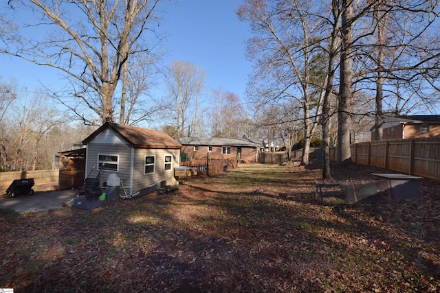 view of yard featuring an outdoor structure and a fenced backyard