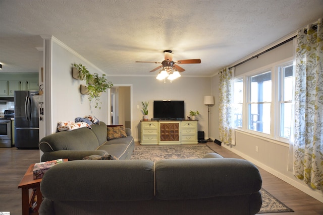 living area with baseboards, ceiling fan, ornamental molding, wood finished floors, and a textured ceiling