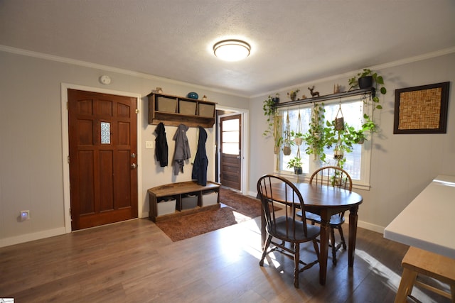 dining area featuring dark wood-style floors and crown molding