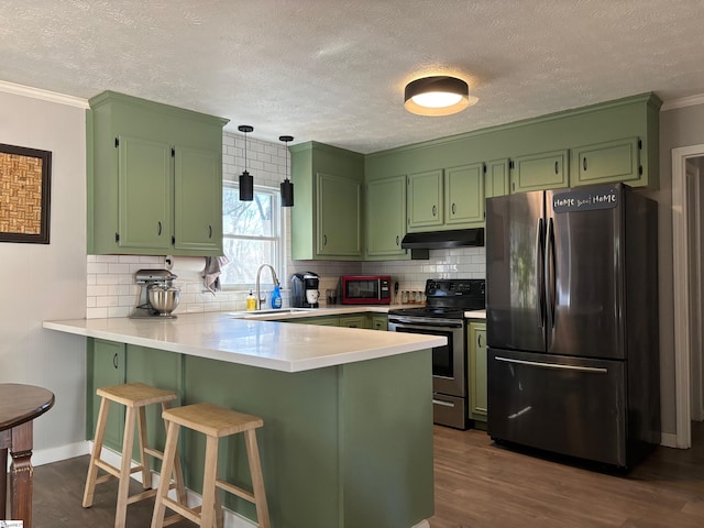 kitchen with a peninsula, electric range, a sink, light countertops, and freestanding refrigerator