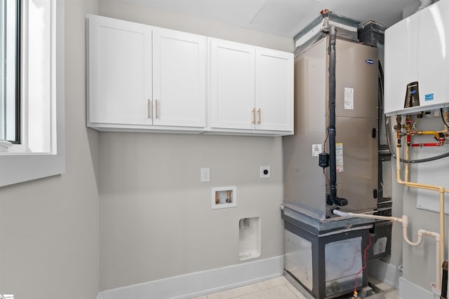 laundry area with hookup for an electric dryer, washer hookup, baseboards, water heater, and cabinet space