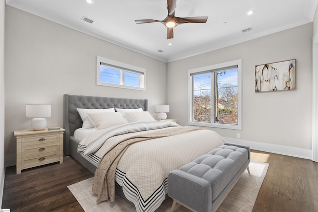 bedroom featuring baseboards, visible vents, dark wood-style flooring, and crown molding