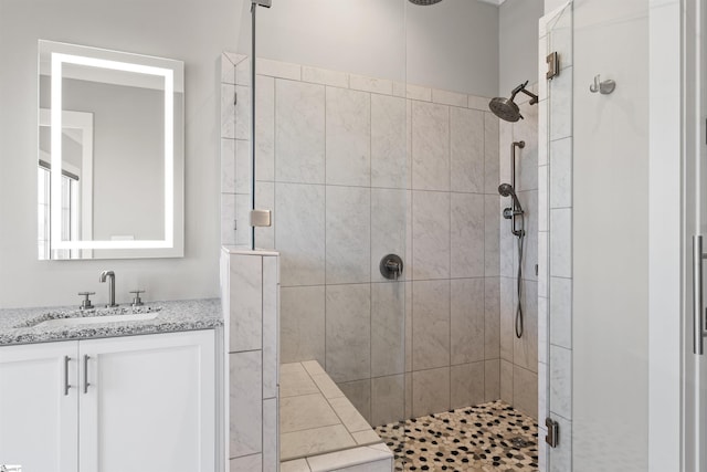 bathroom featuring vanity and a shower stall