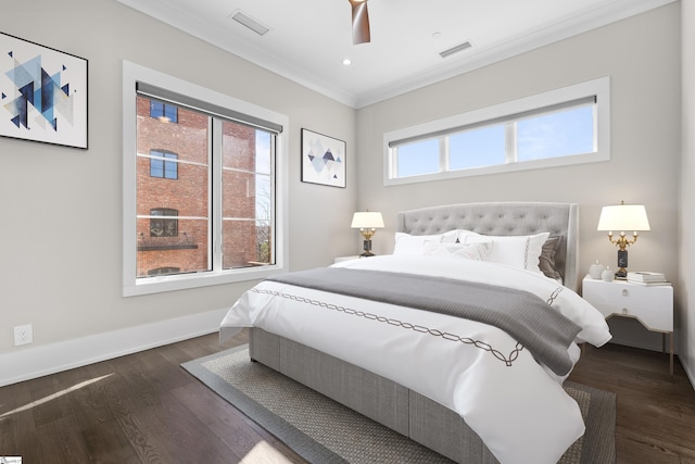 bedroom featuring dark wood-style floors, baseboards, visible vents, and ornamental molding