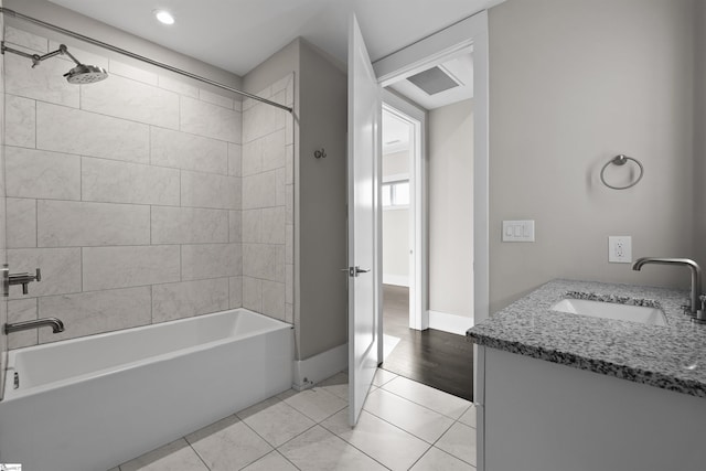 bathroom with washtub / shower combination, tile patterned flooring, vanity, and baseboards