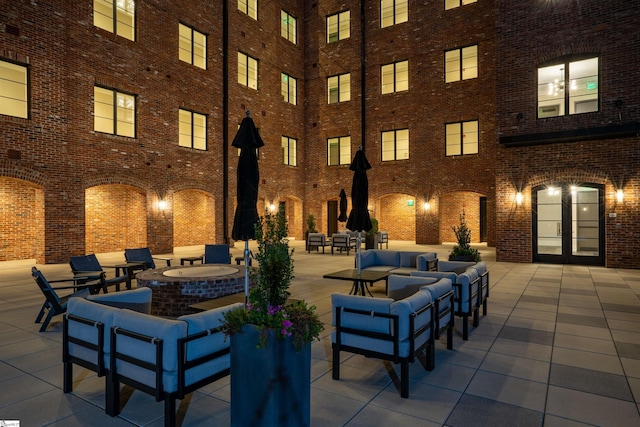 view of patio with an outdoor living space with a fire pit