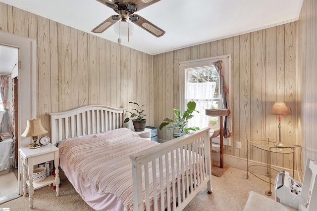 bedroom with light carpet and a ceiling fan