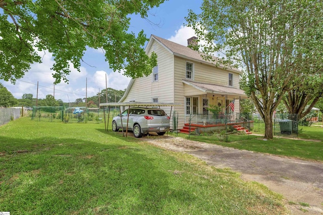 view of front facade featuring covered porch, a shingled roof, fence, a front lawn, and a chimney