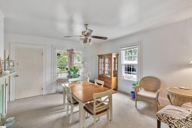 dining room featuring light carpet and ceiling fan