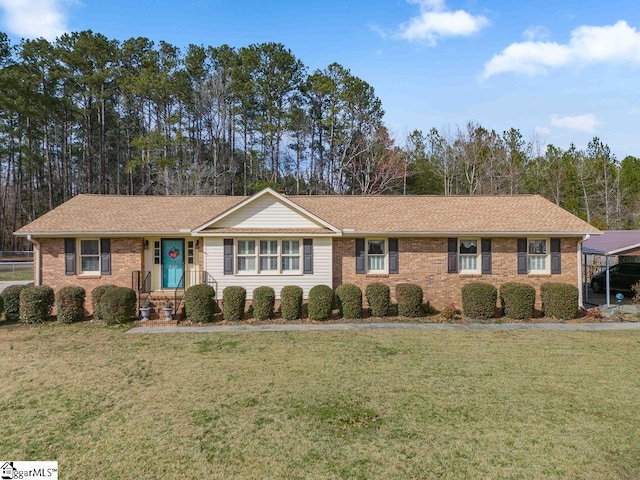 ranch-style house with a front yard, brick siding, and roof with shingles