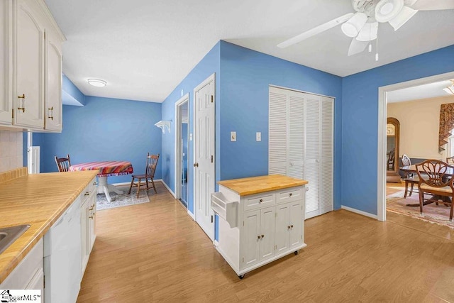 kitchen with white dishwasher, white cabinetry, and light wood-style floors