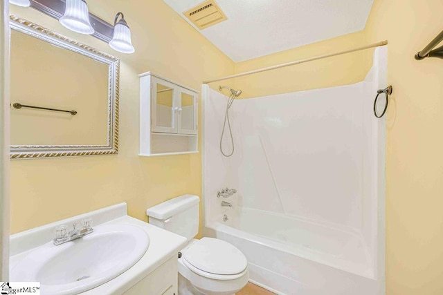 full bathroom with visible vents, toilet, vanity, and shower / tub combination