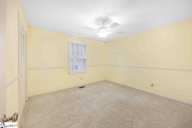 unfurnished bedroom featuring baseboards, ceiling fan, a textured ceiling, carpet flooring, and a closet