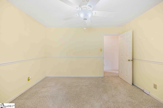 empty room featuring carpet flooring, ceiling fan, and baseboards