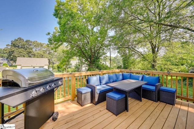 wooden terrace with a grill and an outdoor living space