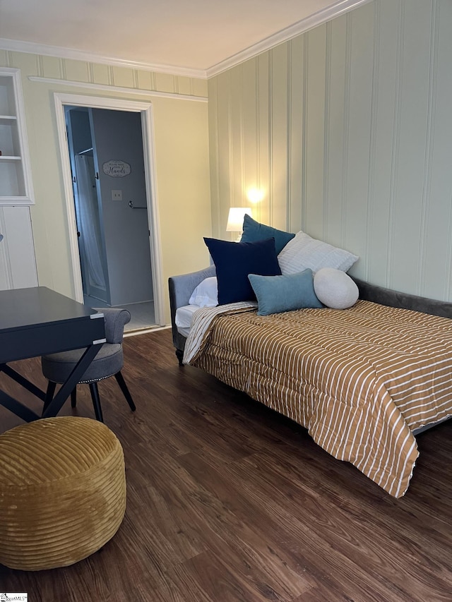 bedroom with ornamental molding and dark wood-type flooring