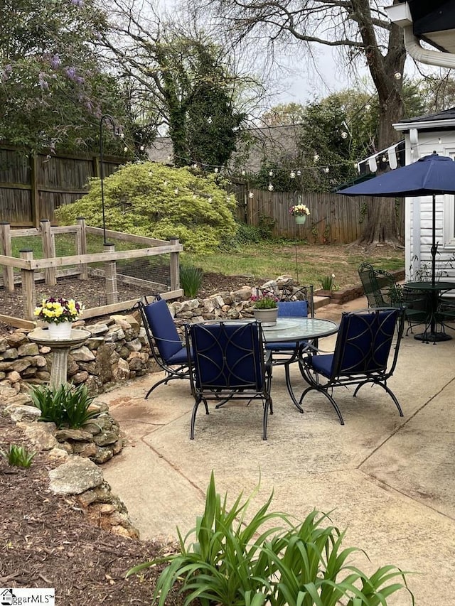 view of patio with a fenced backyard and outdoor dining space