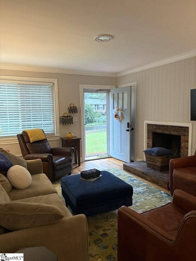 living room with ornamental molding, a fireplace, and wood finished floors