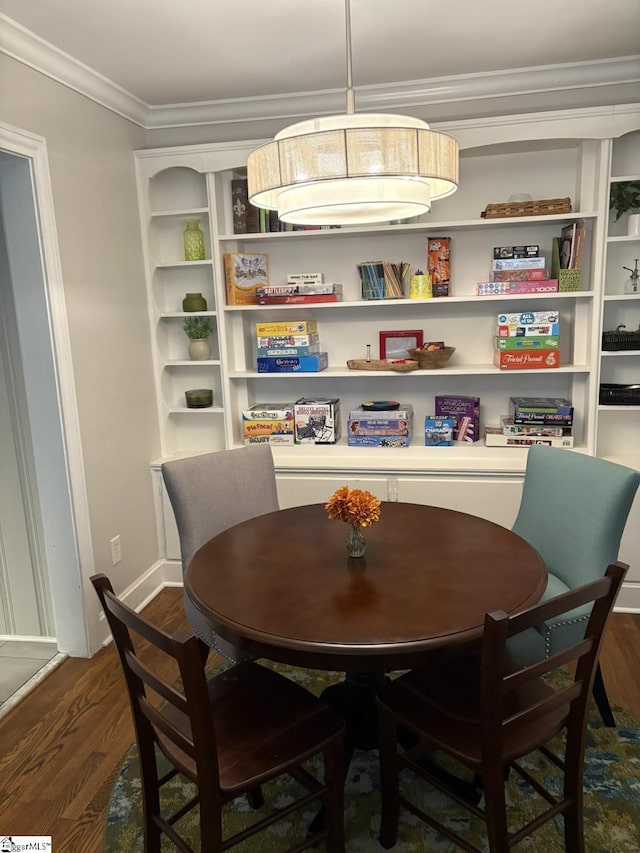 dining area with dark wood-style floors, baseboards, and crown molding