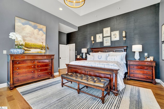 bedroom with recessed lighting, light wood-style flooring, and baseboards