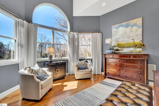 sitting room featuring a healthy amount of sunlight, light wood finished floors, baseboards, and visible vents