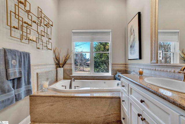 full bathroom featuring a garden tub and vanity