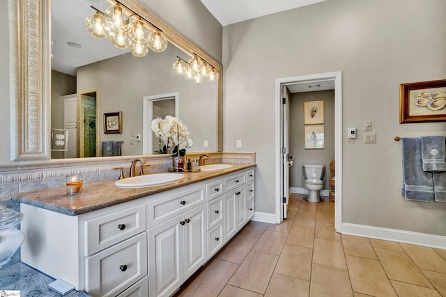 full bath with double vanity, a sink, toilet, and tile patterned floors