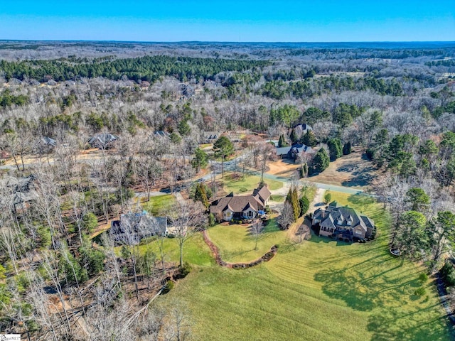 birds eye view of property featuring a wooded view